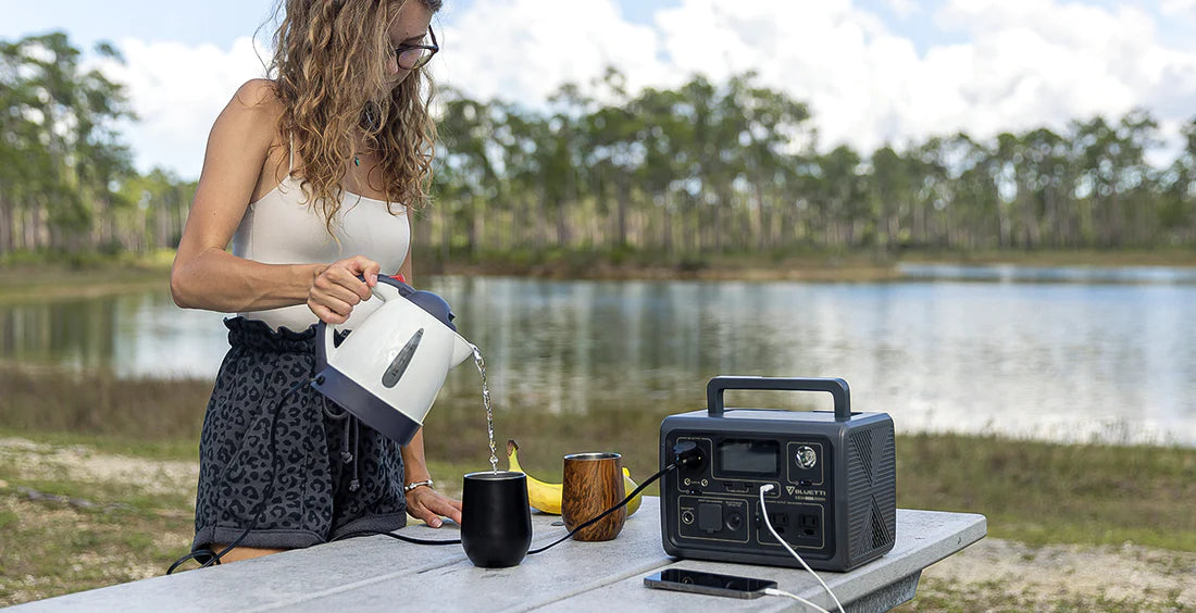BLUETTI portable power station powering devices outdoors near water